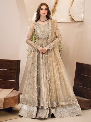 Model wearing a champagne-gold net gown richly embroidered with silver zari and sequins, paired with a sheer embellished dupatta and silver brocade lehenga, from the Epoque Collection at House of Hania.