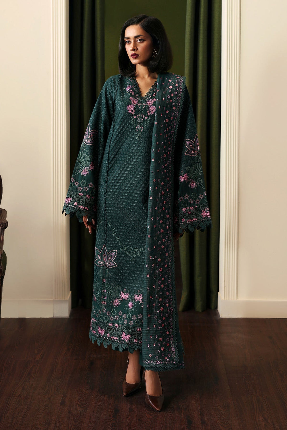 Model wearing Afrozeh Aurun bottle green embroidered lawn suit
