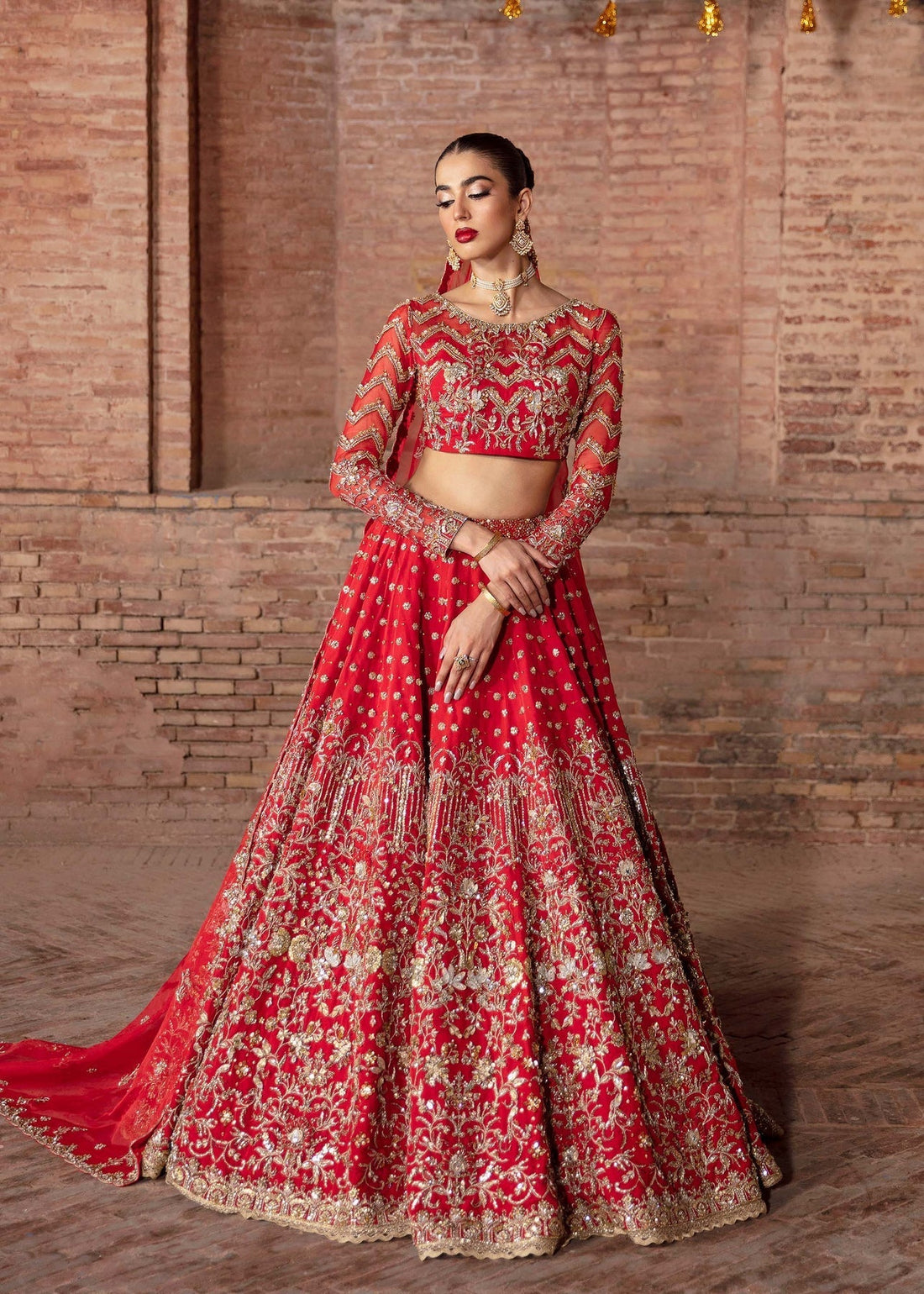 Model wearing Akbar Aslam CHRYSALIS pinkish red blouse & lehenga with dupatta