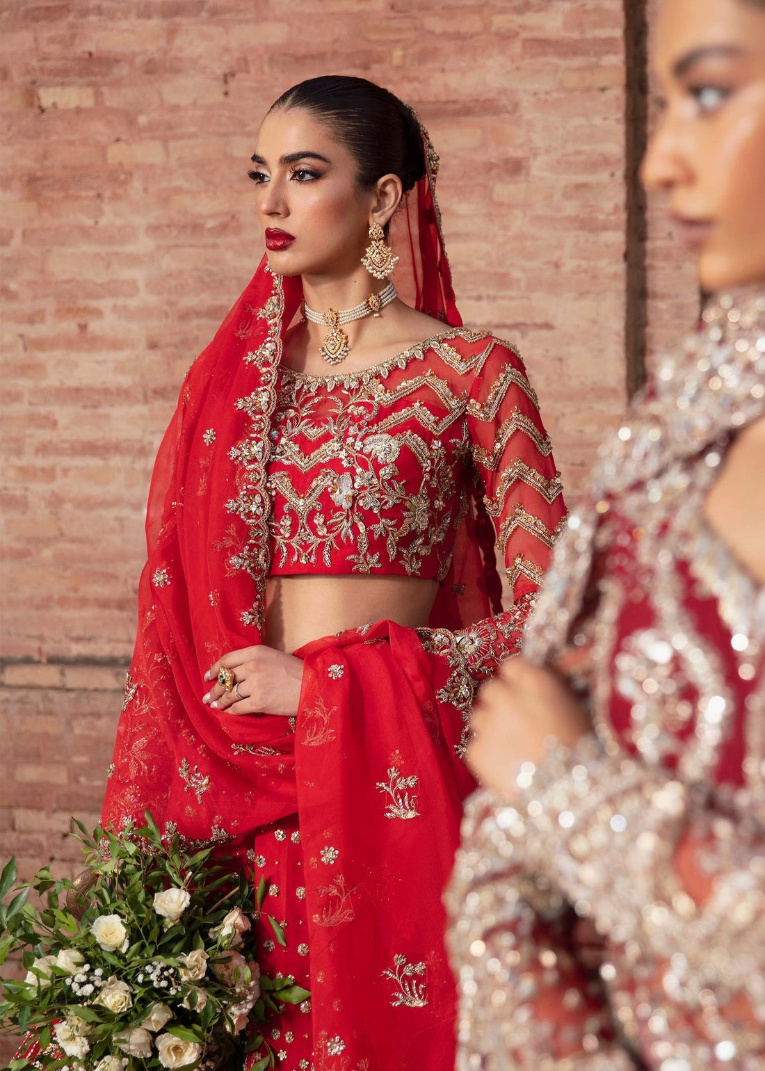 Model wearing Akbar Aslam CHRYSALIS pinkish red blouse & lehenga with dupatta