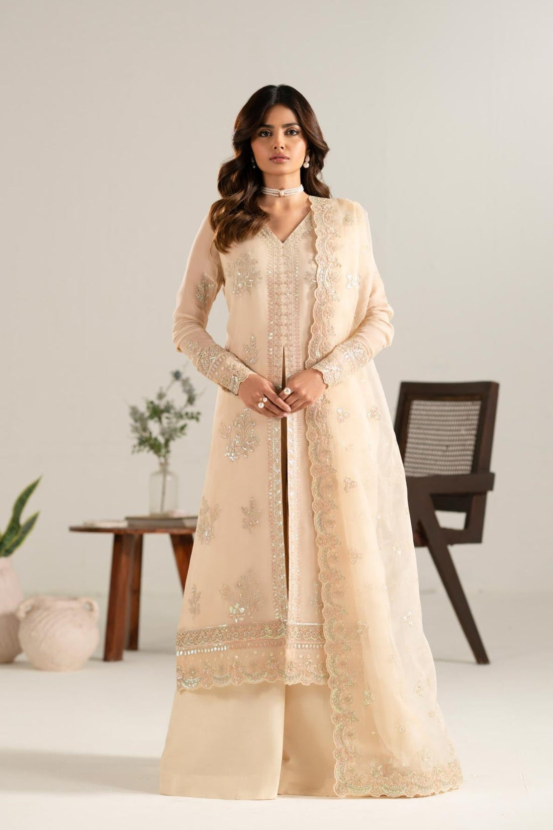Model wearing Akbar Aslam Zarlish gold blouse & lehenga with dupatta