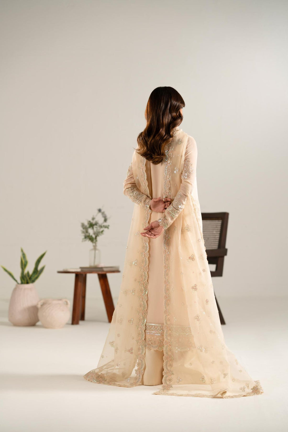 Model wearing Akbar Aslam Zarlish gold blouse & lehenga with dupatta